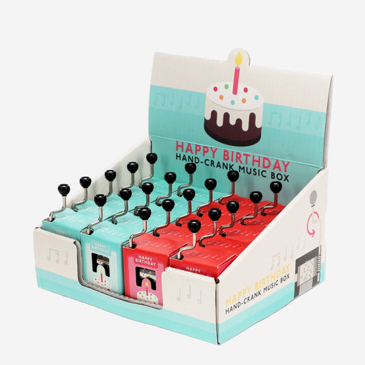 Display of 'Happy Birthday' hand-crank music boxes with packaging.