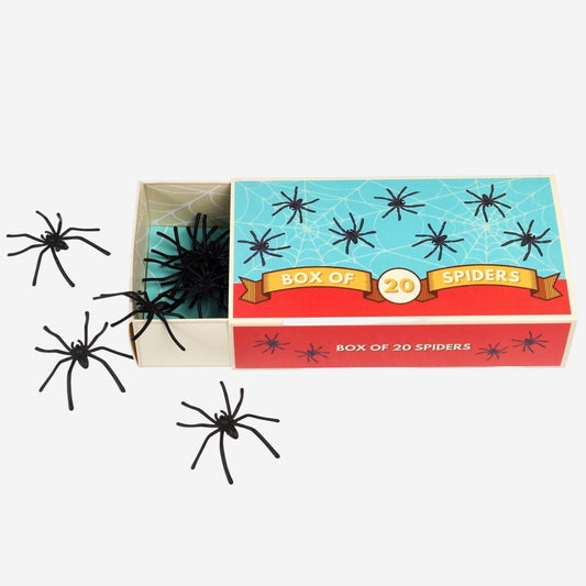 Box of spiders with black spiders spilling out on a white background