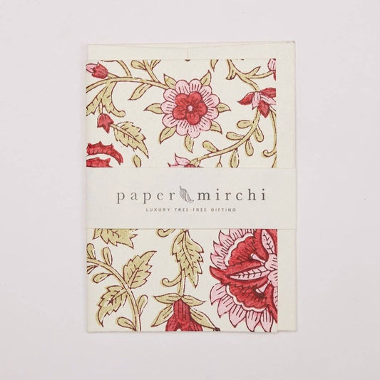 Product packaging with floral design and 'paper mirchi' branding on a light background