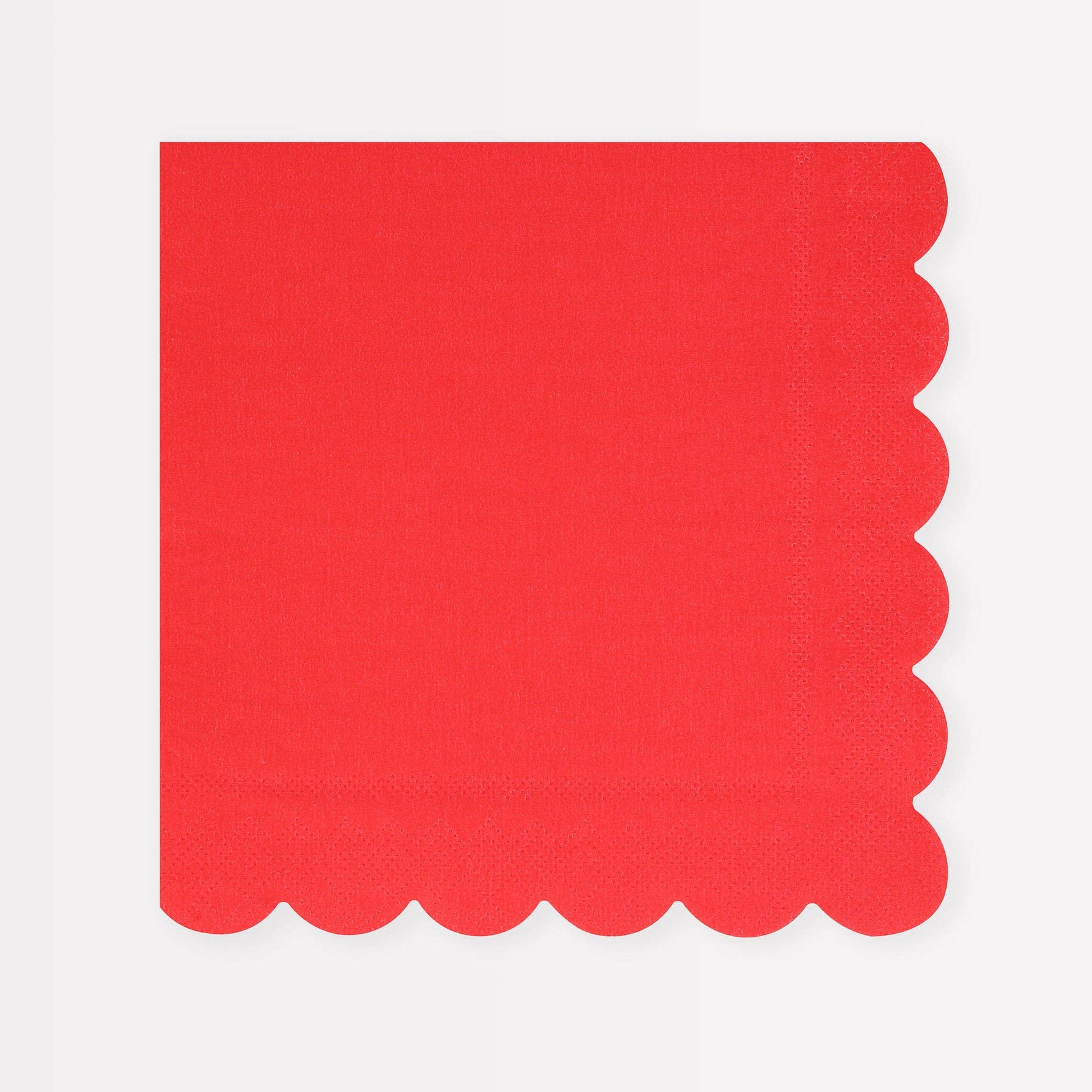 Red napkin with scalloped edge on a white background