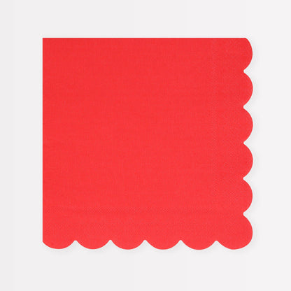 Red napkin with scalloped edge on a white background