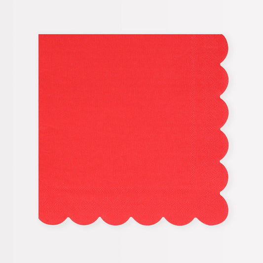 Red napkin with scalloped edge on a white background
