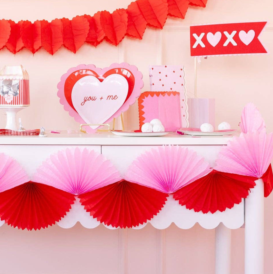 Valentine's Day themed table with heart decorations and a pink and red color scheme.