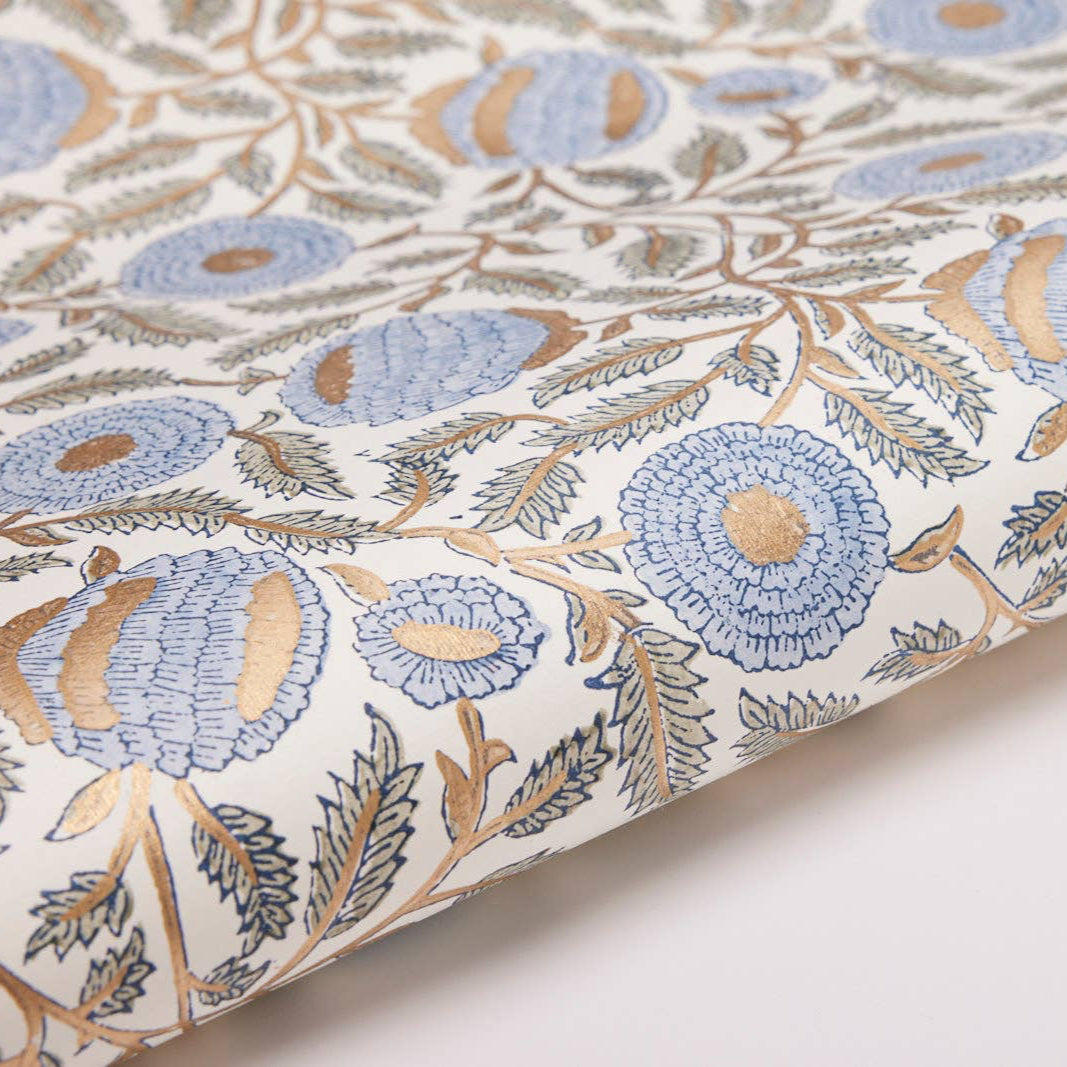 Floral patterned fabric with blue and beige flowers on a white background