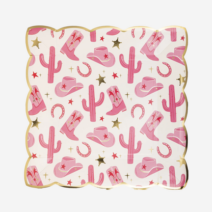Decorative paper plate with pink cowboy hats, boots, and cacti on a white background