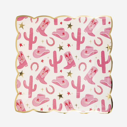 Decorative paper plate with pink cowboy hats, boots, and cacti on a white background
