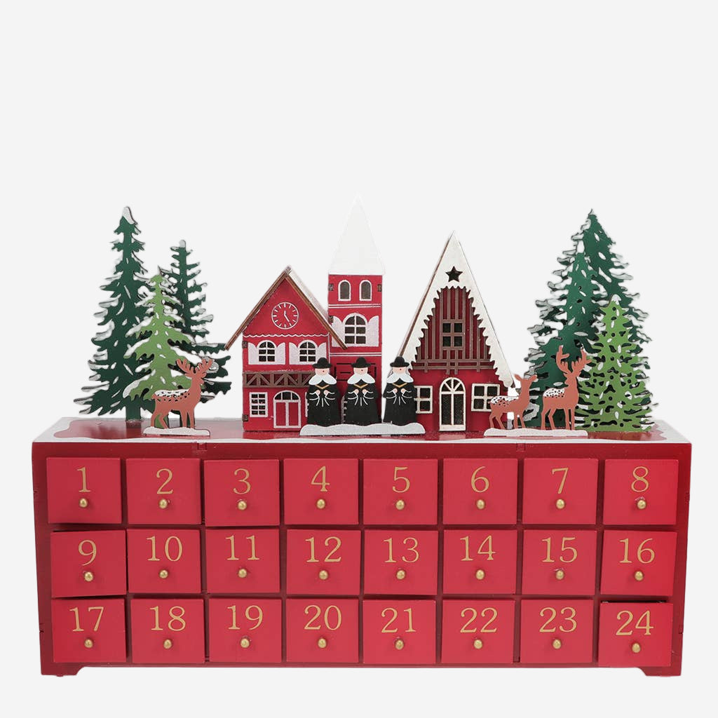 Red Advent calendar with Christmas village scene and trees on top