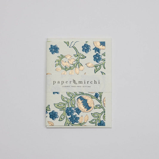 Book with floral design and 'paper mirchi' branding on a light gray background