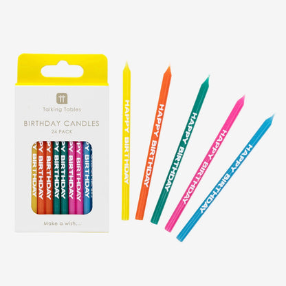 Set of colorful birthday candles with packaging on a white background