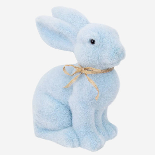 Blue bunny plush toy with a bow on a white background
