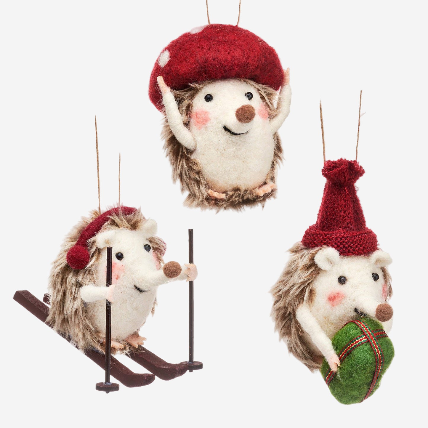 Set of three festive hedgehog ornaments with red hats on a white background
