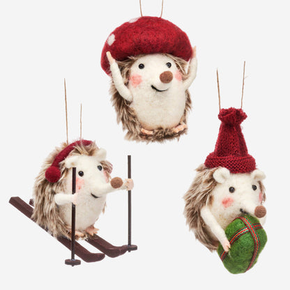 Set of three festive hedgehog ornaments with red hats on a white background