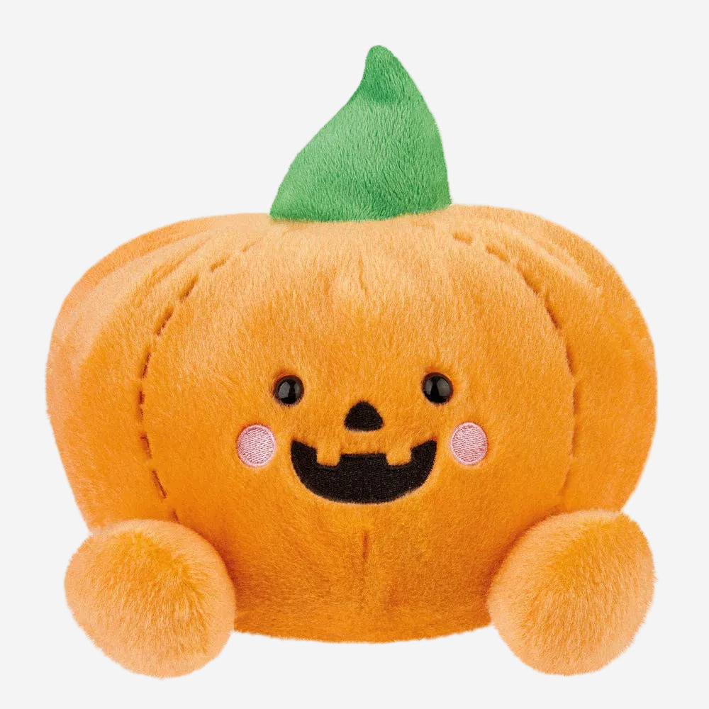 Plush pumpkin toy with a smiling face on a white background
