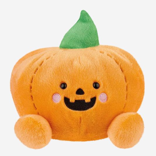 Plush pumpkin toy with a smiling face on a white background