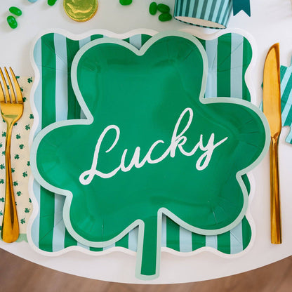 Green shamrock-shaped plate with 'Lucky' text on a festive table setting.
