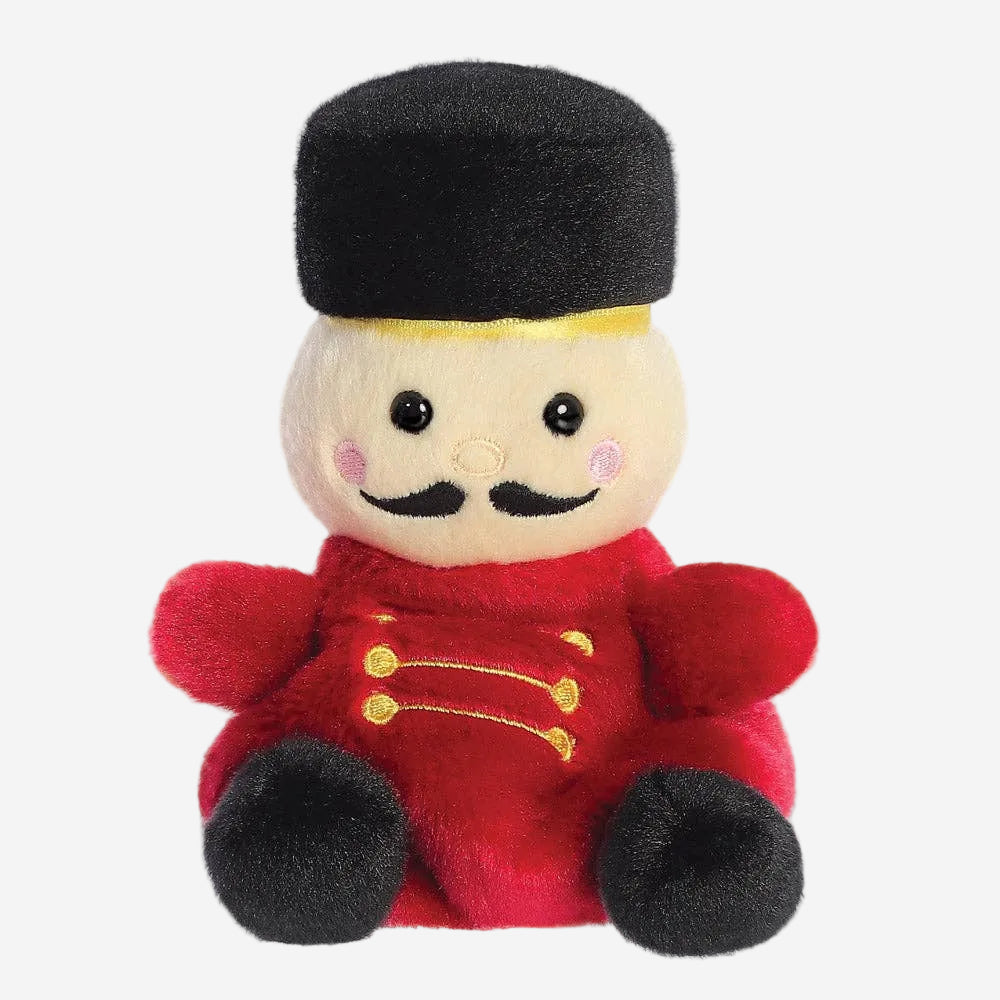 Plush toy resembling a bellhop character with a red uniform and black hat on a white background
