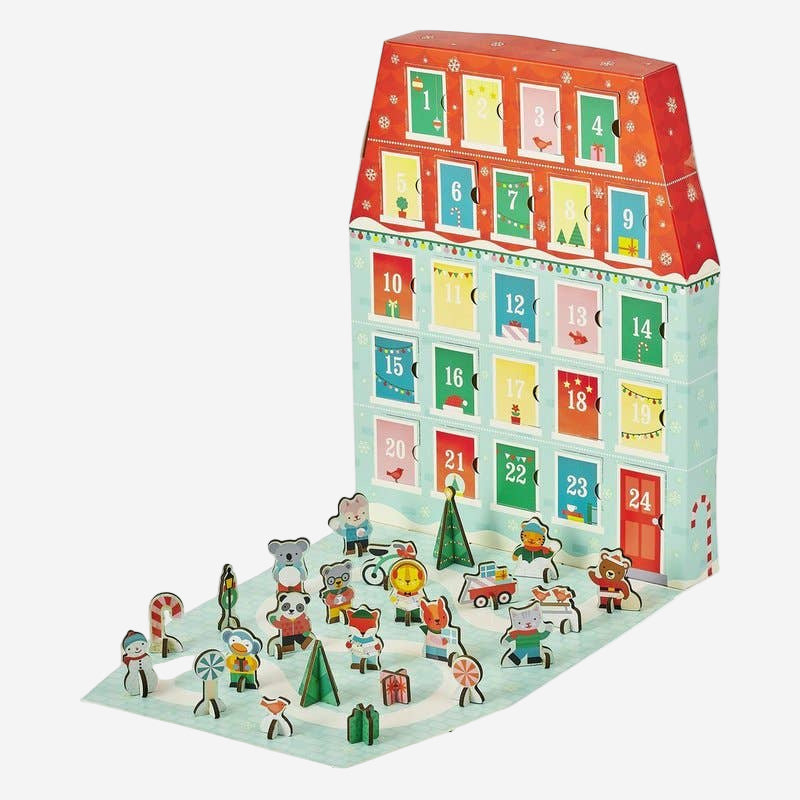Advent calendar shaped like a house with numbered doors and small figures on a white background