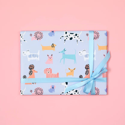 Gift wrapped in blue paper with animal pattern on a pink background