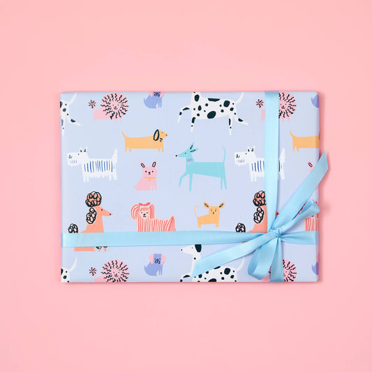 Gift wrapped in blue paper with animal pattern on a pink background