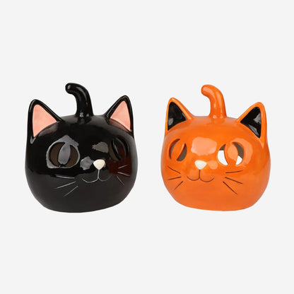 Black and orange cat-shaped ceramic jars on a white background