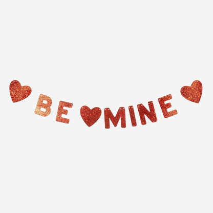 Glittery 'BE MINE' text with heart symbols on a white background