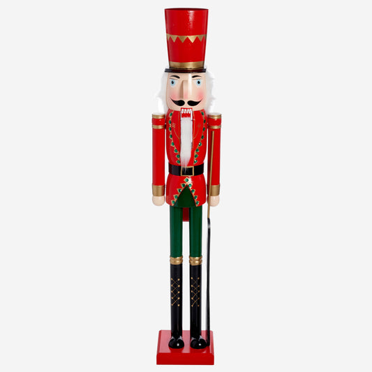 Decorative nutcracker figurine with red top and green pants on a white background
