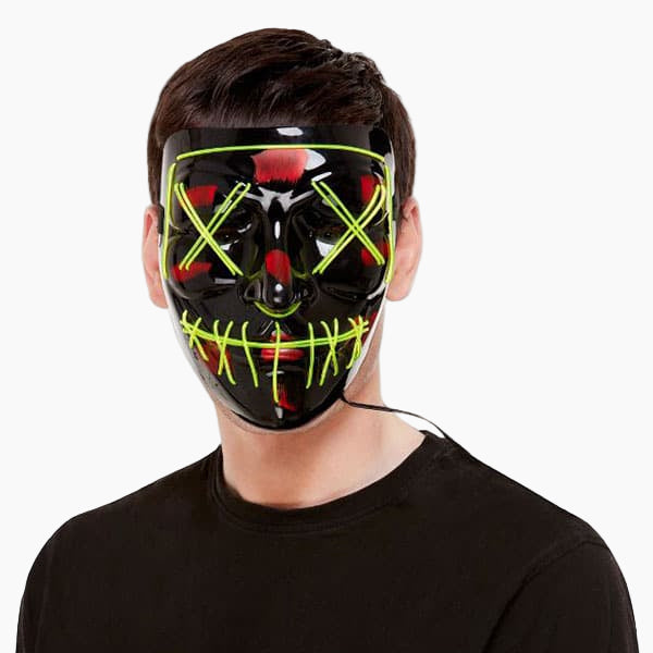 Person wearing a black mask with green and red accents on a white background