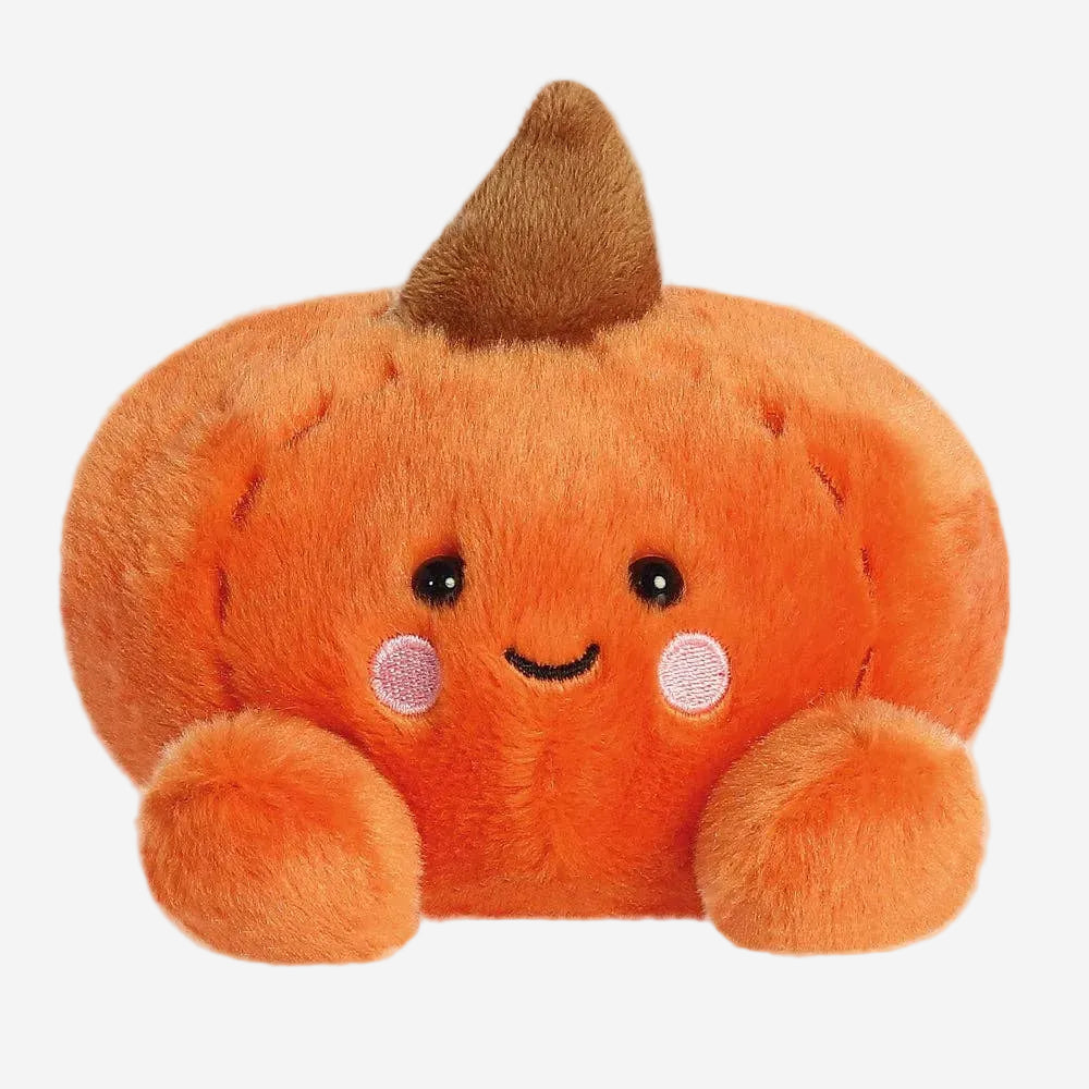 Plush pumpkin toy with a smiling face on a white background