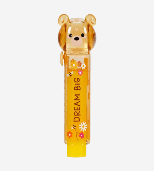 Yellow lip balm with bear design and 'Dream Big' text on a white background