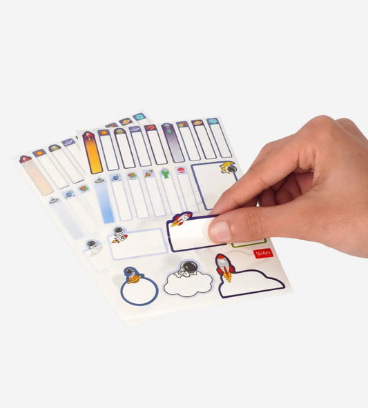 Hand holding a colorful set of name tags with various designs on a white background