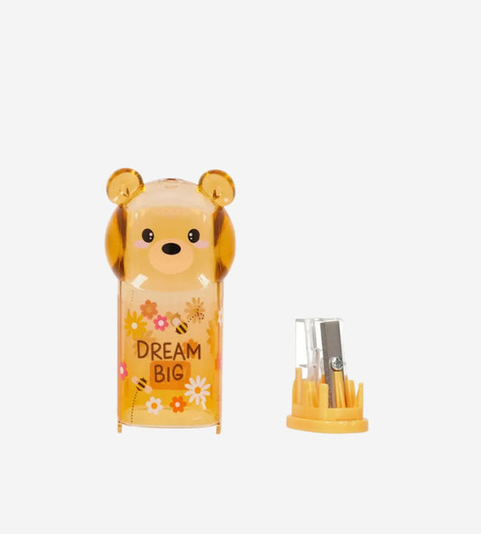 Cute bear-shaped container with 'Dream Big' text and small tools on a white background