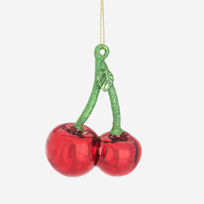Decorative ornament with red cherries and green stem on a white background