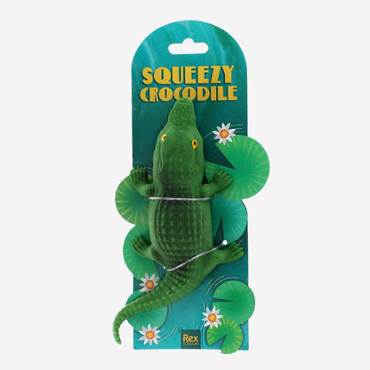 Green crocodile toy with packaging labeled 'Squeezy Crocodile' on a white background